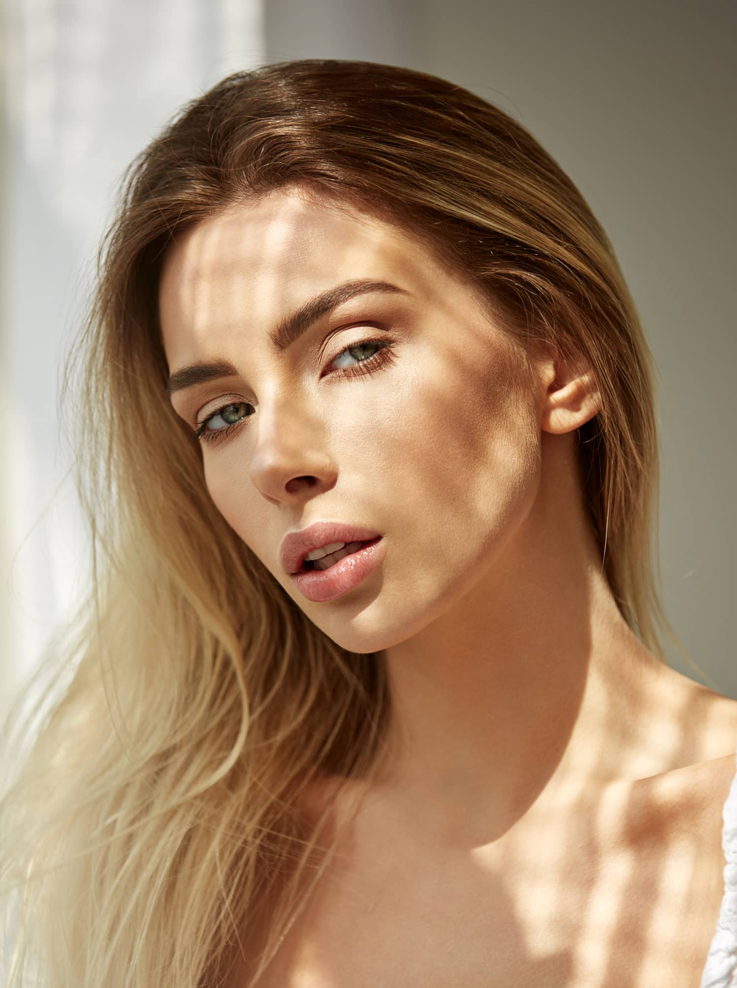 Close-up portrait of young beautiful blonde woman posing in photo studio Premier Plastic Surgery in Newport Beach, CA